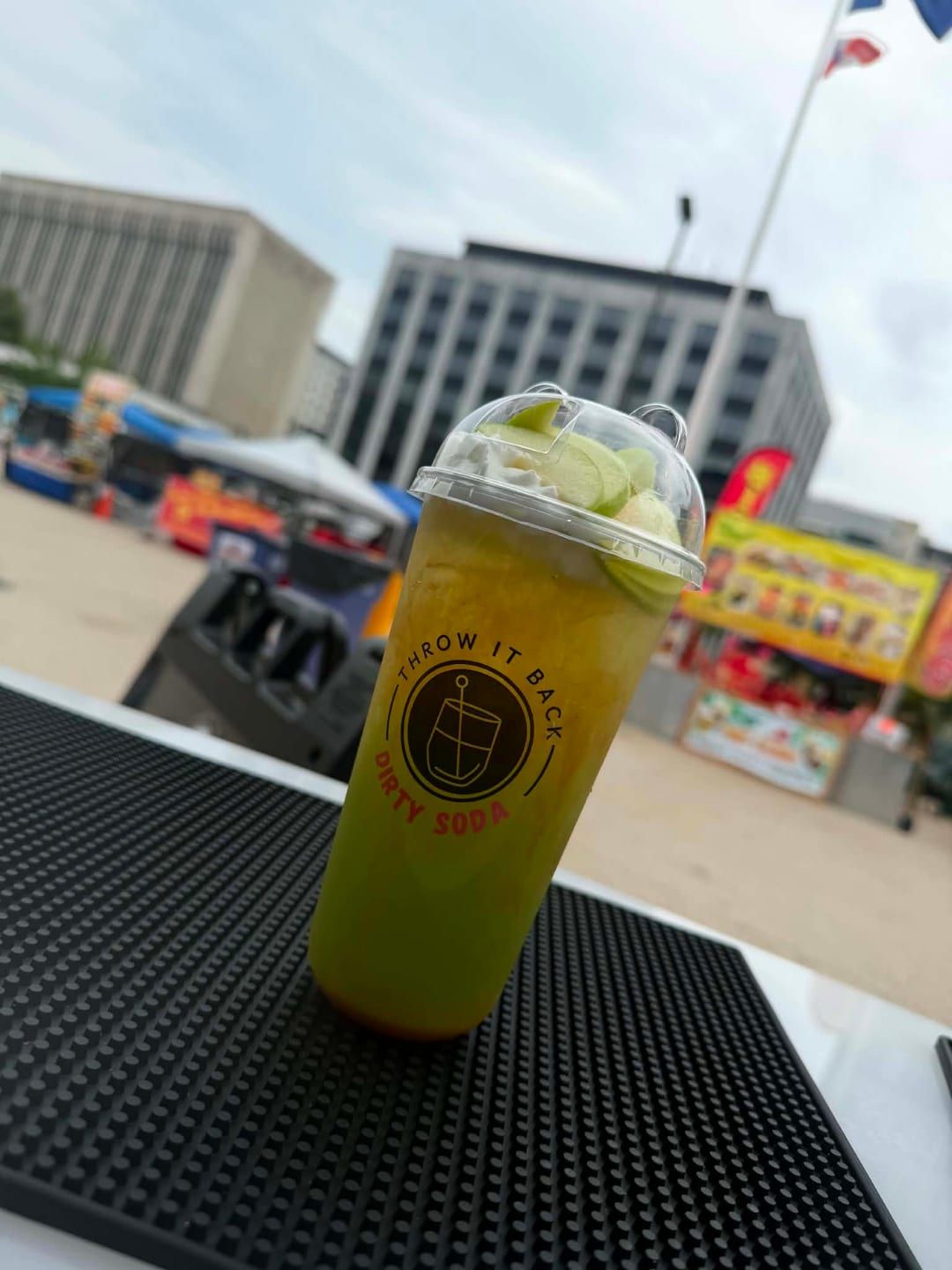 An apple loaded dirty soda served at an outdoor event